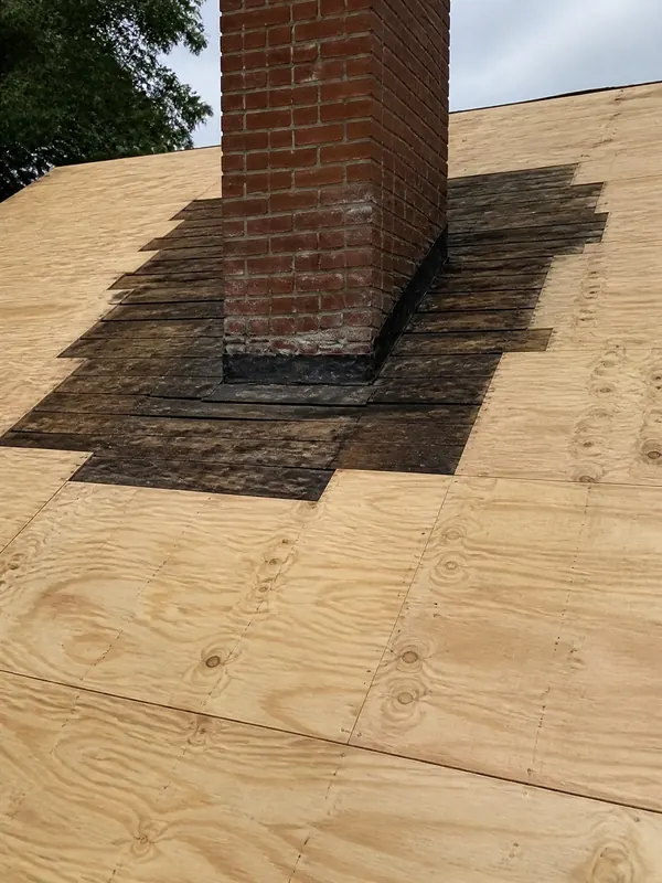 Chimney base on new roof decking before flashing